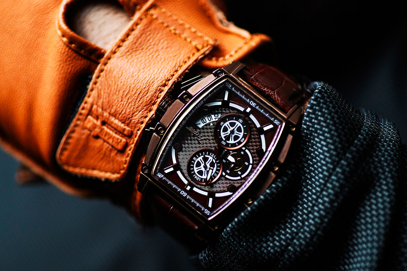 Luxury watch with detailed face on a wrist, wearing a brown leather strap.