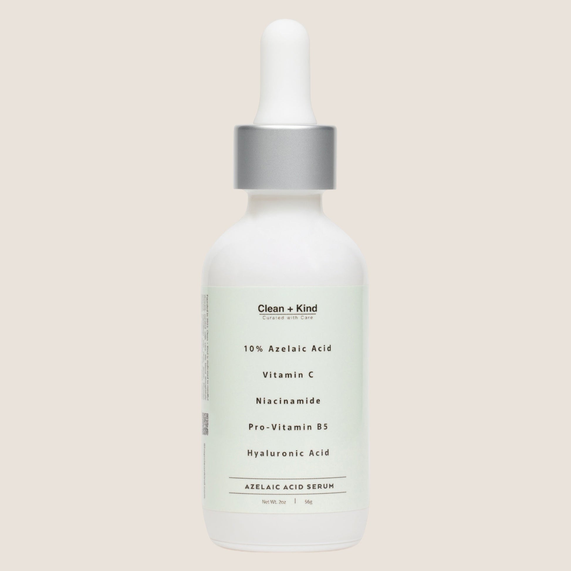 Skincare serum bottle with dropper on a light beige background