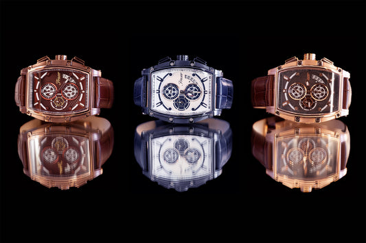 Three luxury watches with reflective surfaces on a black background