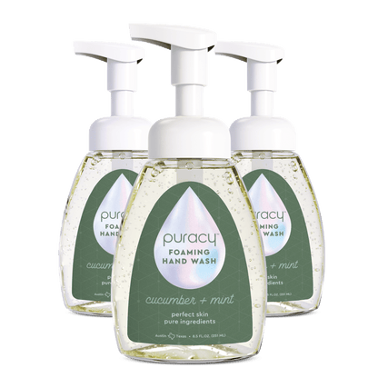 Three bottles of Puracy Foaming Hand Wash on a green background